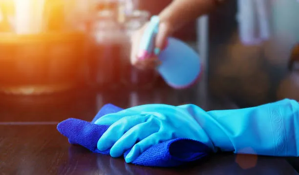 cleaner using microfibre cloth to clean surfaces